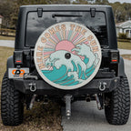 Here Comes the Sun spare tire cover on red Bronco rear with boho sun and crashing waves