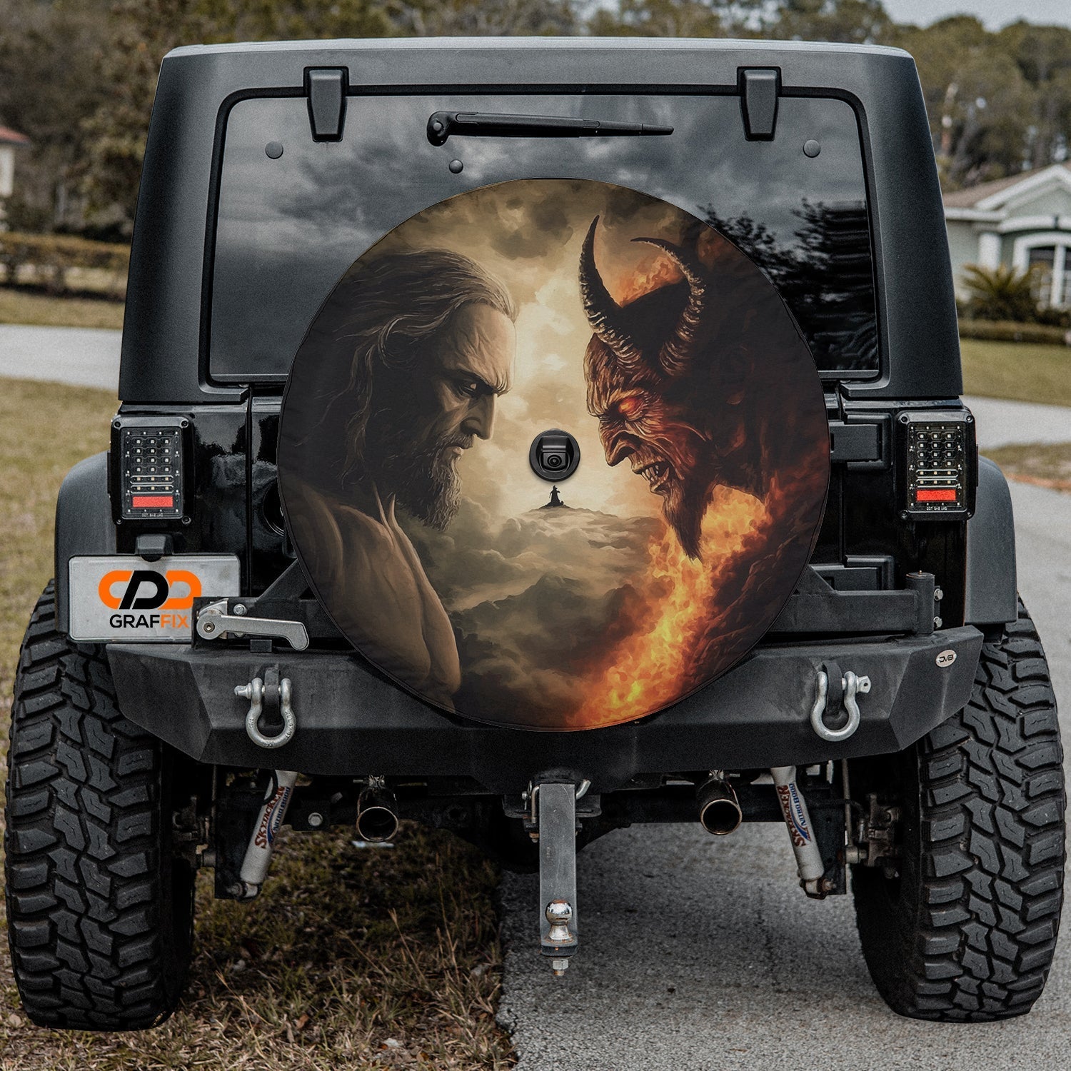Heaven vs Hell Ultimate Battle spare tire cover on black Jeep Wrangler rear with deity confronting devil