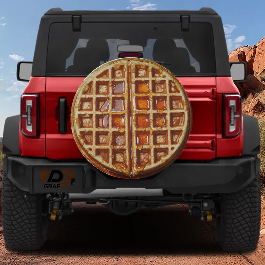 Maple syrup Belgian waffle spare tire cover rear angle view on parked Jeep Wrangler