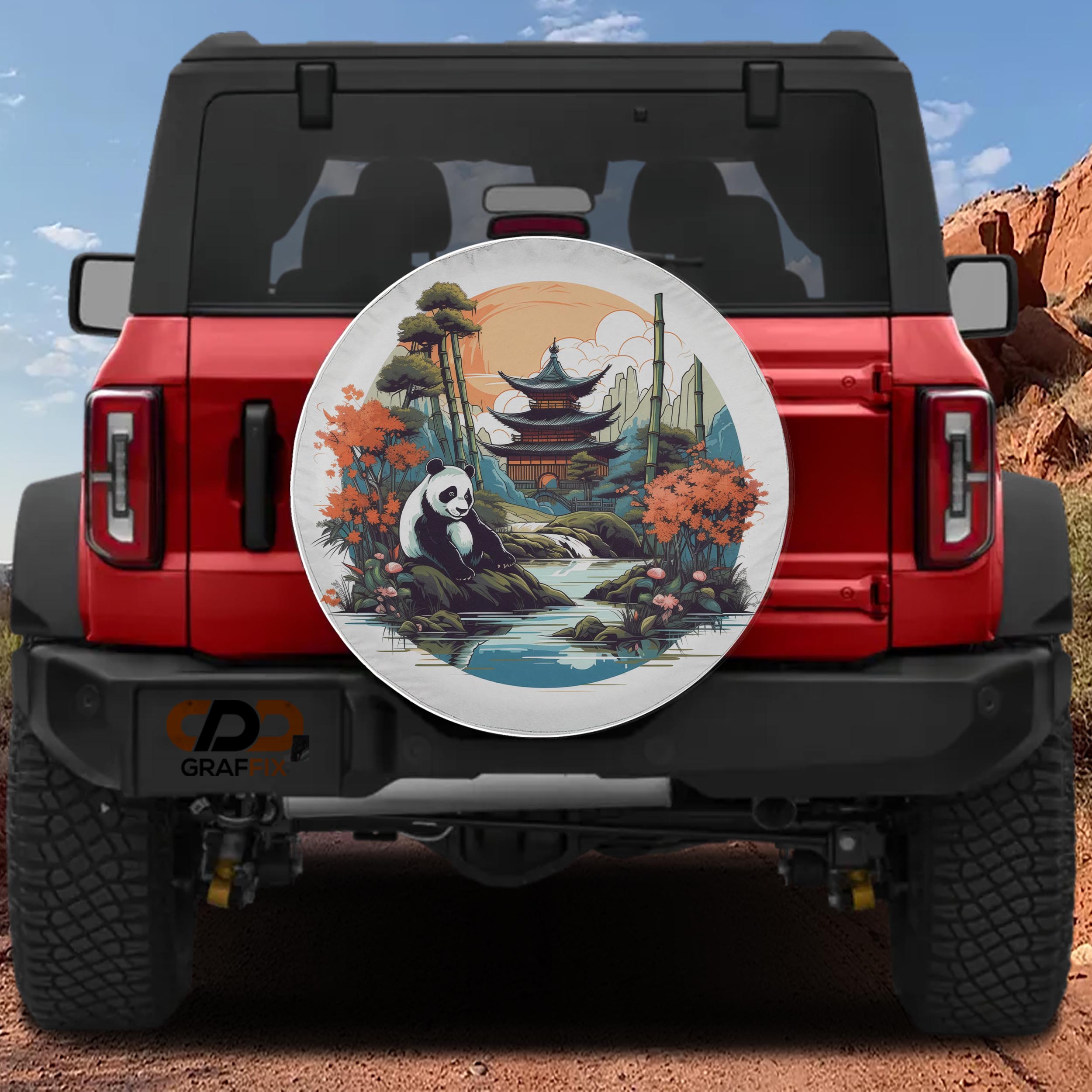 A red Jeep Wrangler with a large, decorative wheel cover featuring a panda bear and a scenic landscape.