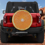 Orange fruit spare tire cover with vibrant citrus slice graphic and bright orange peel design