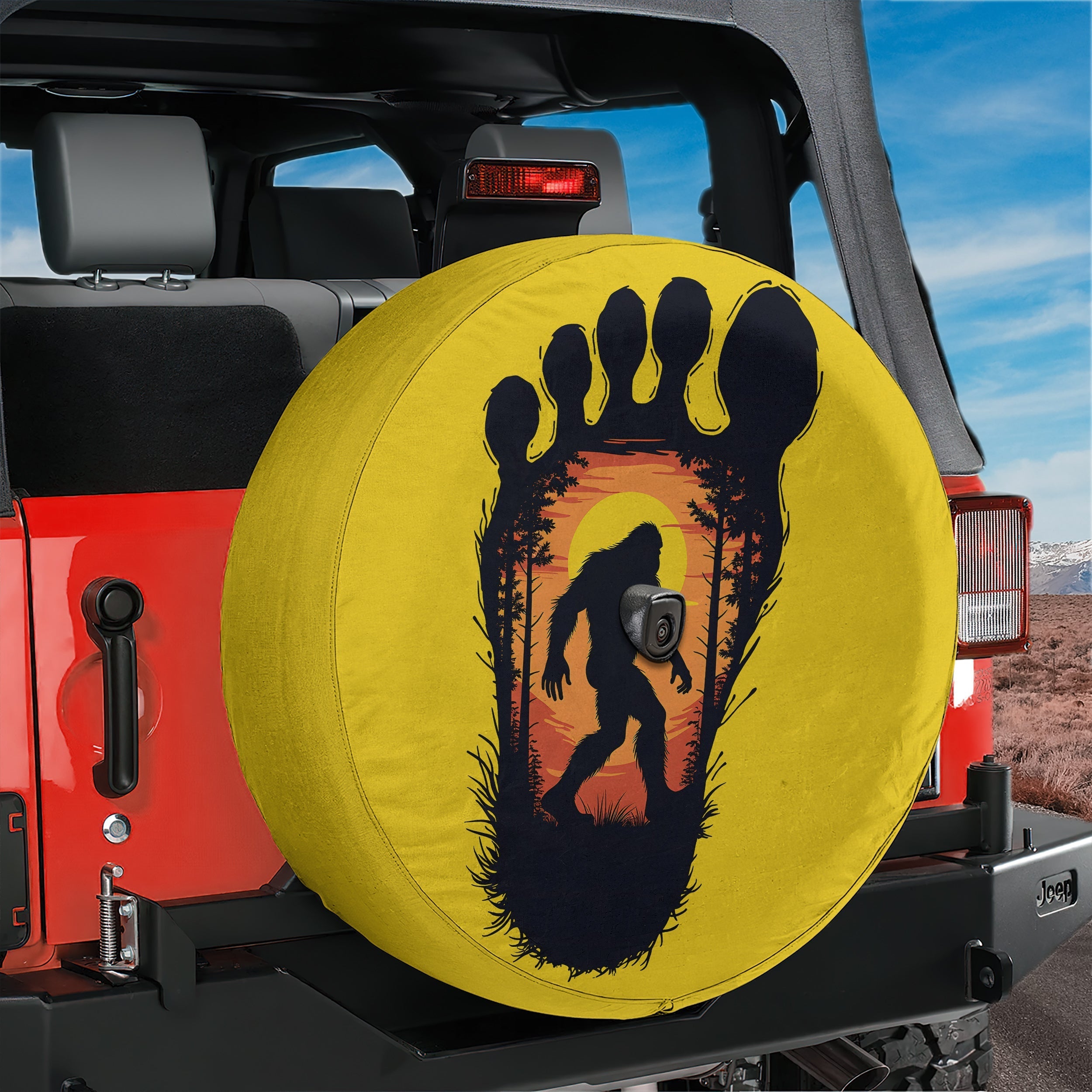Squatch Track spare tire cover lifestyle view showcasing Bigfoot walking inside giant footprint art