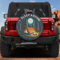 I Sleep Around camping edition tire cover on a red Ford Bronco with tent campfire moon and pine trees