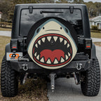Shark Bite spare tire cover on red Bronco rear with cartoon shark biting graphic