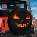A Jeep Wrangler with a Halloween-themed spare tire cover featuring a jack-o-lantern design.