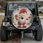 Christmas gnome spare tire cover on black Jeep Wrangler featuring rustic gnome holding present design