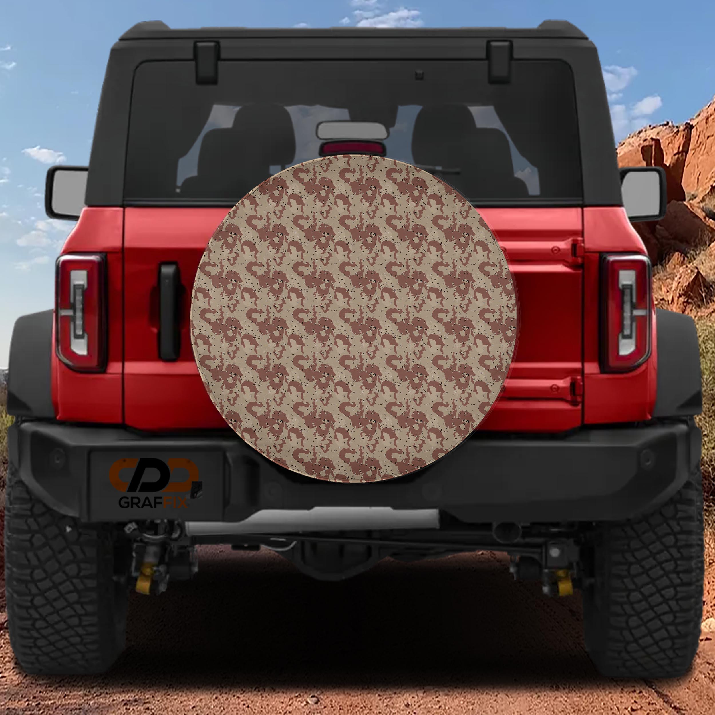 Tan and brown chocolate chip desert camouflage spare tire cover shown on red Ford Bronco at rear