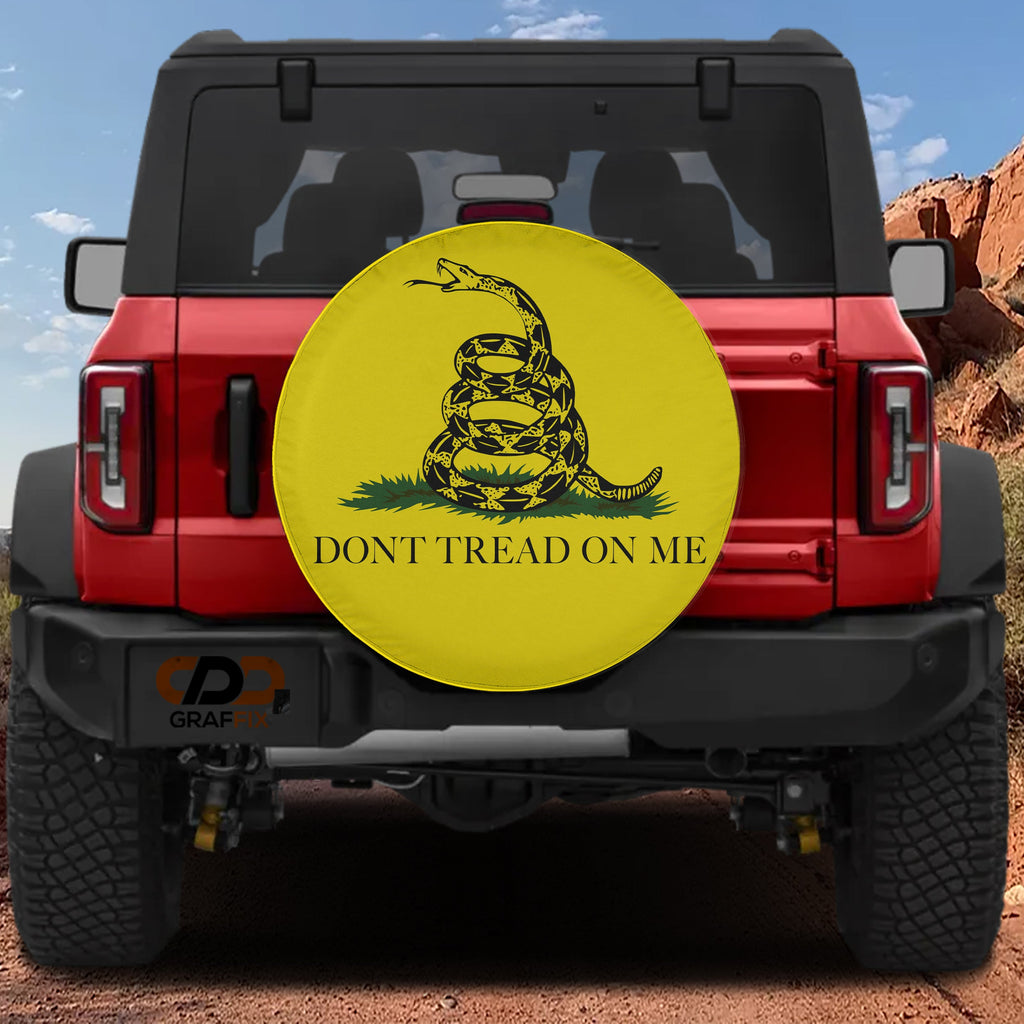 Gadsden Don't Tread on Me tire cover on red Ford Bronco with coiled rattlesnake on yellow with bold text