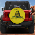Gadsden Don't Tread on Me tire cover on red Ford Bronco with coiled rattlesnake on yellow with bold text