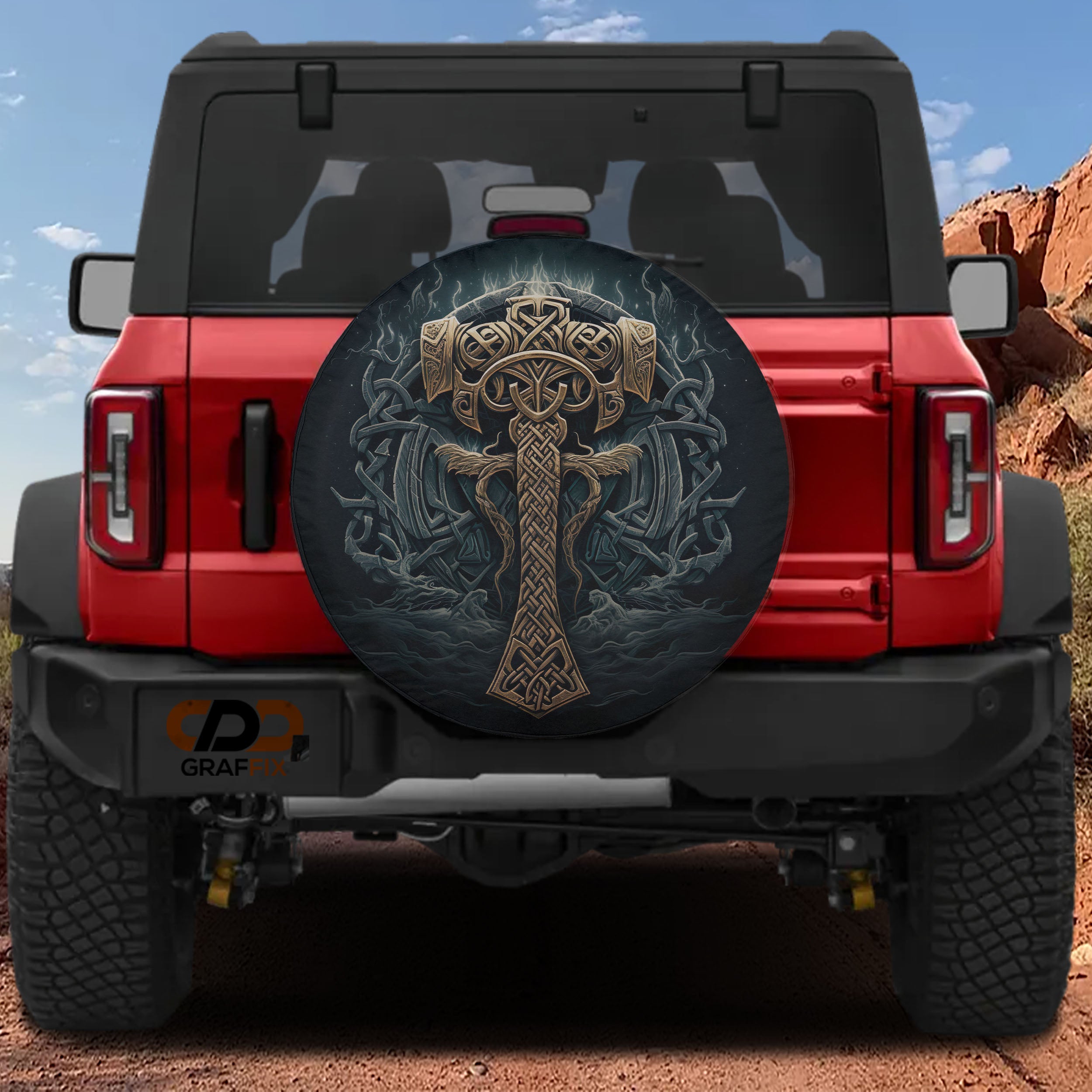 a red Jeep Wrangler with a large, decorative wheel cover on the rear of the vehicle.