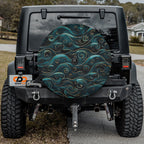 Flat round golden teal waves spare tire cover closeup with rolling ocean swirls in teal and gold linework