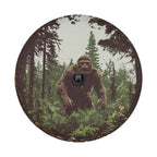 Bigfoot pine trees retro art tire cover mounted on black Jeep Wrangler with GRAFFIX brand plate