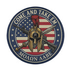a circular emblem with a helmet, crossed swords, and a camera, all set against an American flag background. The text "COME AND TAKE EM" is prominently displayed around the emblem.