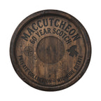 The image is a wooden barrel with embossed text and symbols, including a compass rose and a map, indicating it is a commemorative or promotional item related to a private collection or estate.