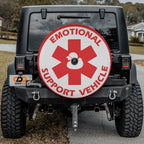Emotional Support Duck red and white medical cross tire cover on red Ford Bronco rear with rocks