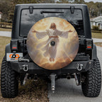 a black Jeep Wrangler with a large chrome wheel cover featuring a painting of Jesus Christ.