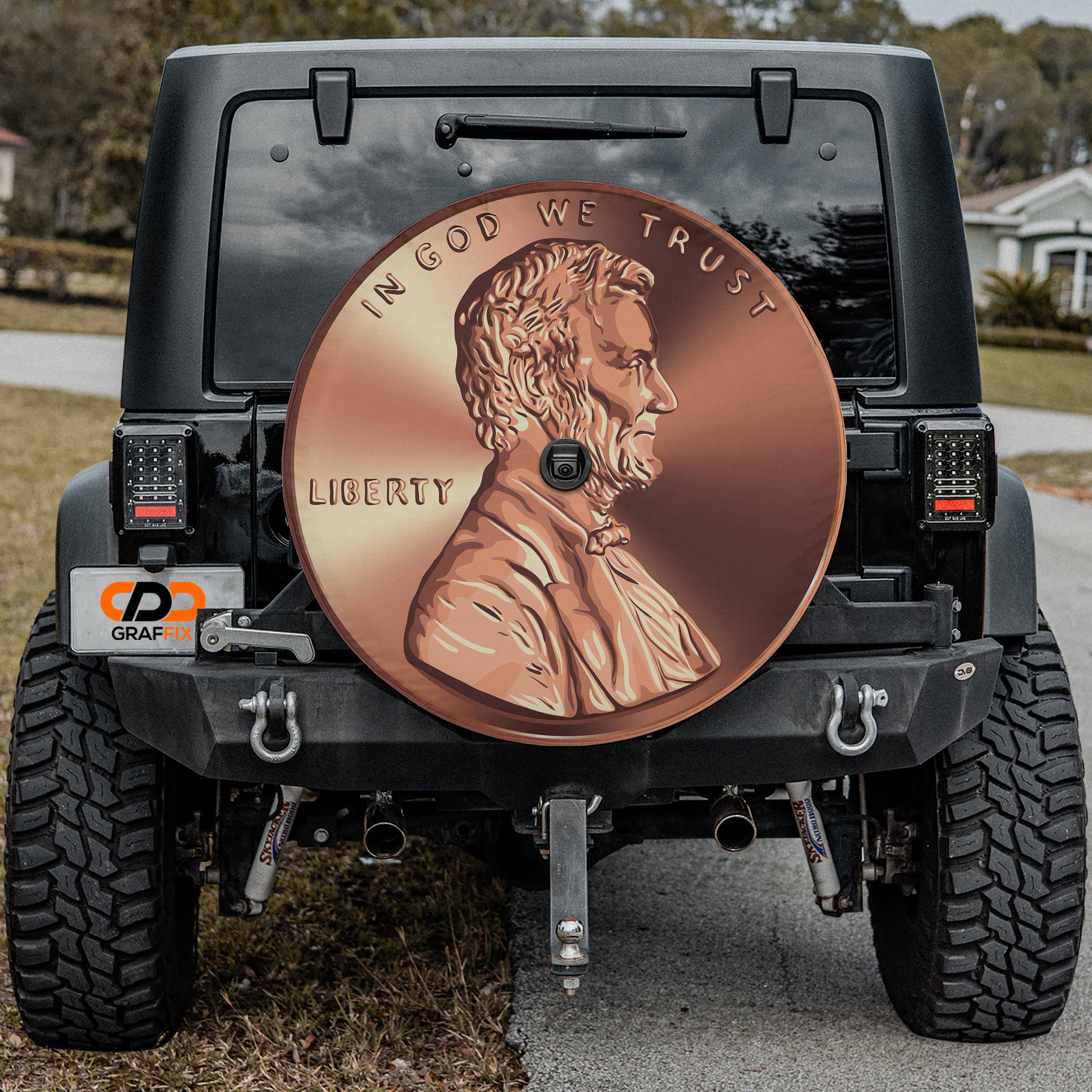 Giant American penny spare tire cover on red Ford Bronco with copper Lincoln penny graphic
