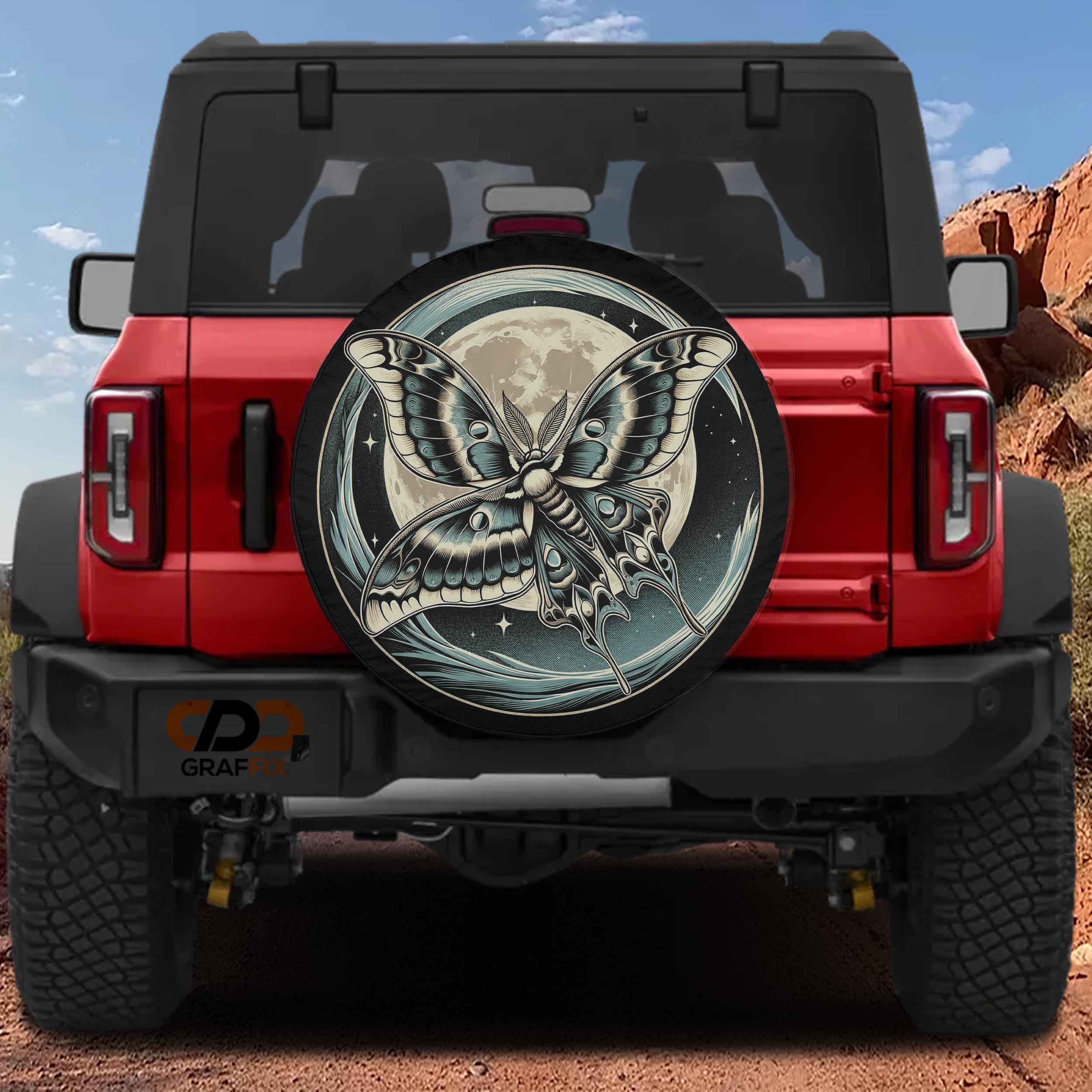 a red Jeep Wrangler with a large, detailed butterfly graphic on the rear tire cover.