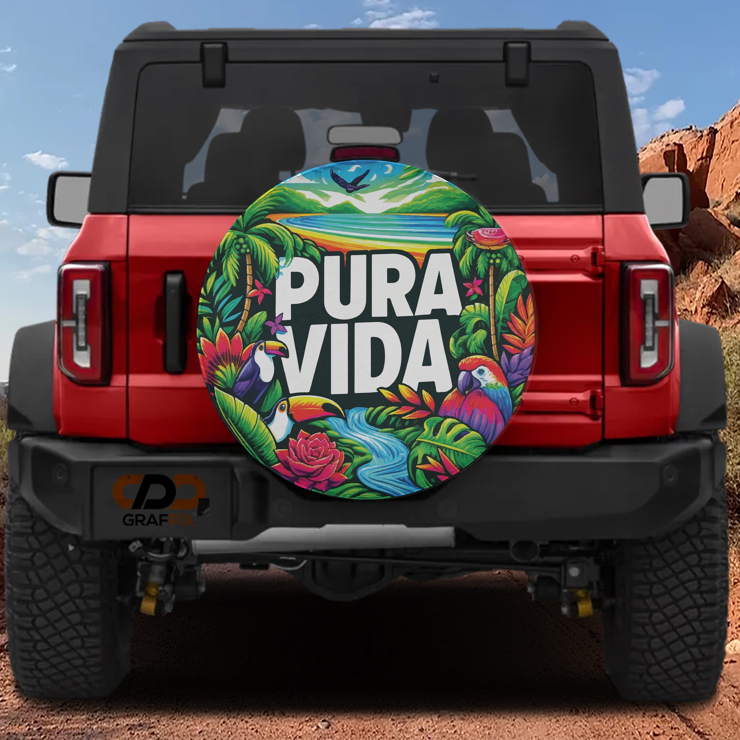 Pura Vida tropical birds spare tire cover with toucan macaw rainforest art on red Ford Bronco SUV