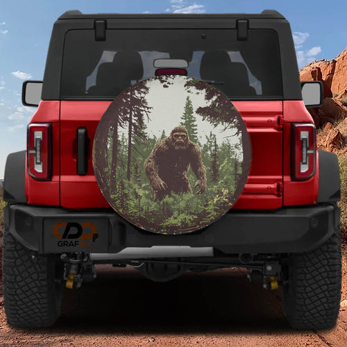 Bigfoot Sasquatch lurking in pine forest spare tire cover mounted on red Ford Bronco desert backdrop
