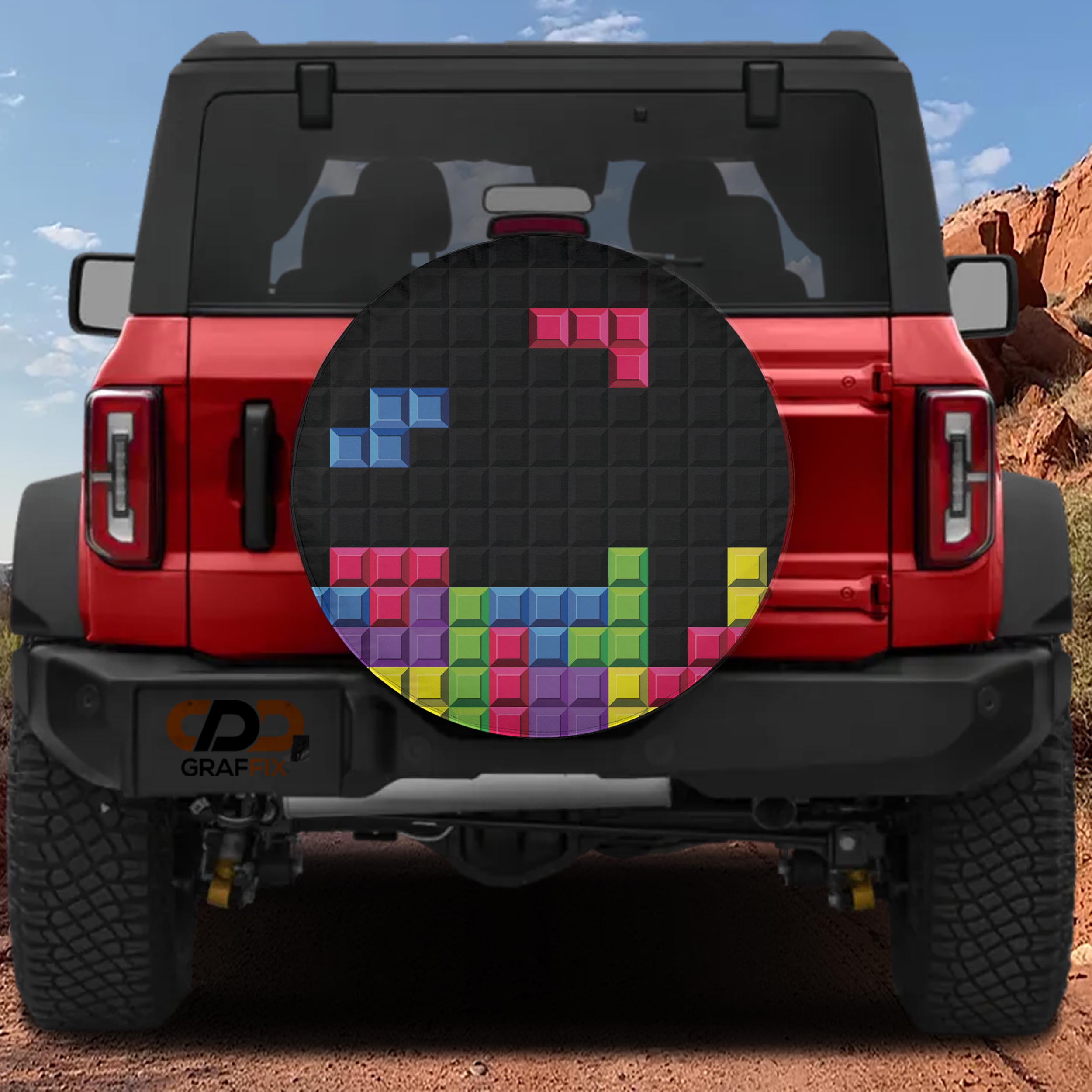 Pixel block puzzle spare tire cover on red Ford Bronco showing colorful Tetris-style brick stacking design