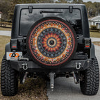 Black Jeep displaying Mandala Wheel spare tire cover with detailed geometric pattern installed