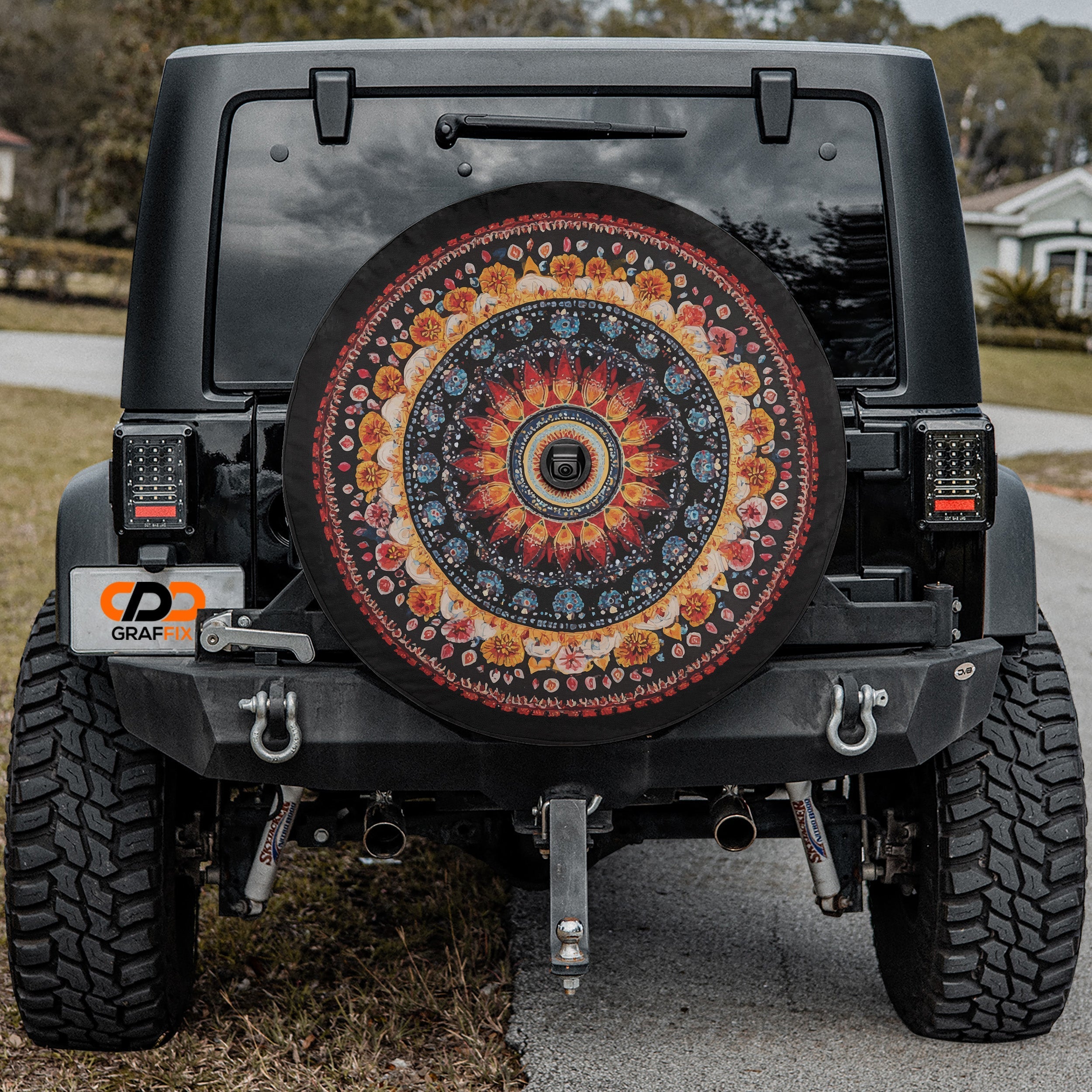 Black Jeep displaying Mandala Wheel spare tire cover with detailed geometric pattern installed