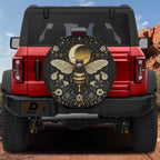 Celestial Buzz bee spare tire cover mounted on a red Bronco rear with golden moon, stars and floral border art