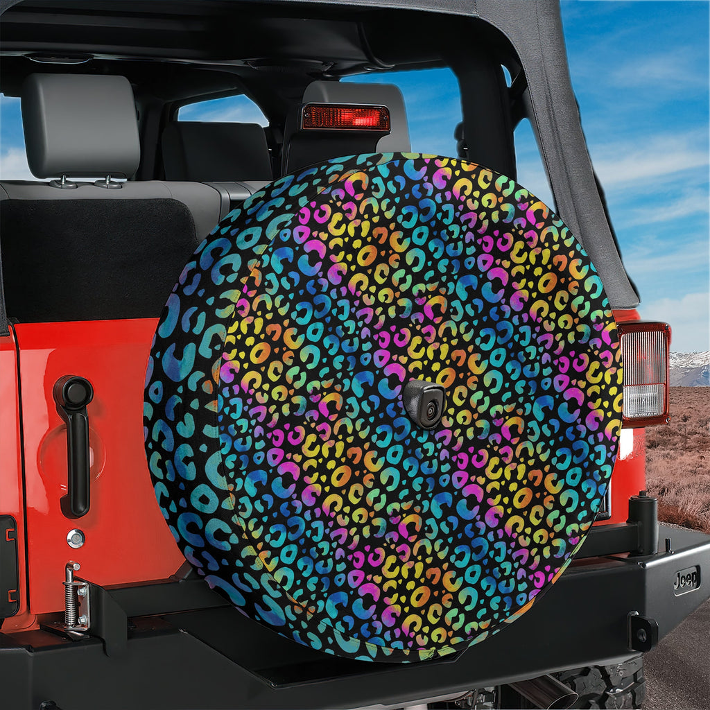 Leopard rainbow print spare tire cover front view on black Jeep Wrangler with backup camera hole