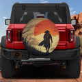 Samurai sunset spare tire cover on red Ford Bronco rear showing warrior silhouette against orange Japanese sun