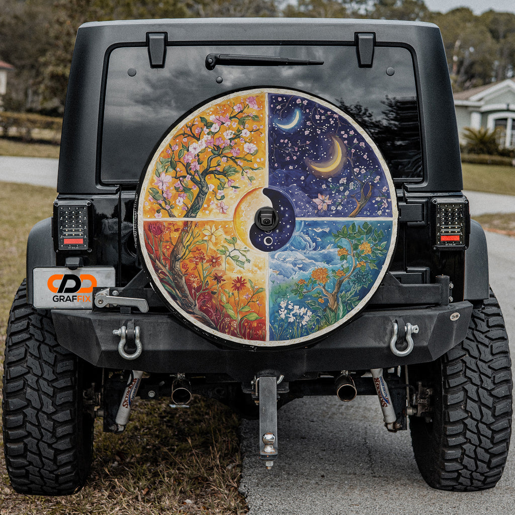 Seasons Change four season tree art tire cover mounted on black Jeep Wrangler with yin yang center