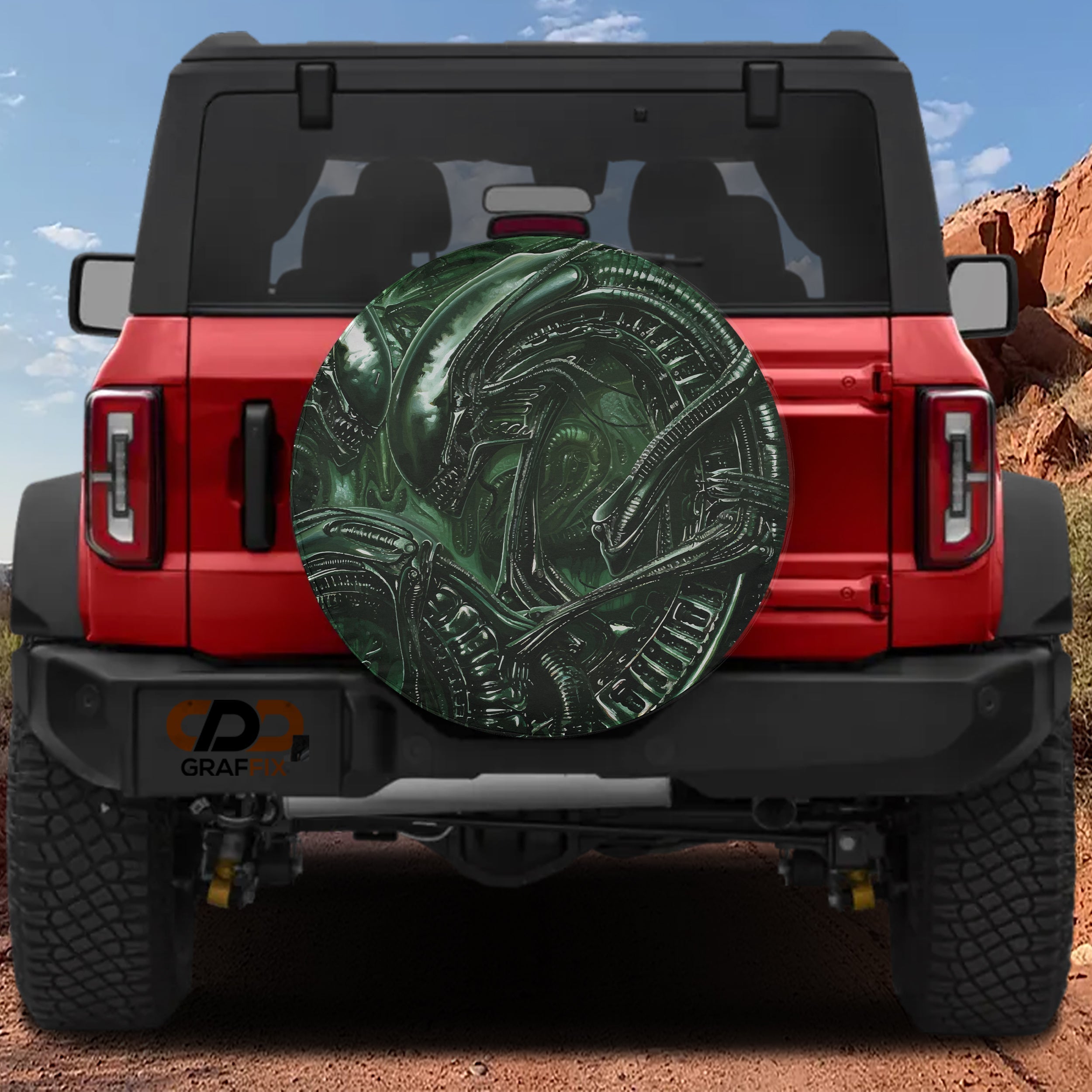 Alien lifeform spare tire cover featuring green H.R. Giger style xenomorph biomechanical artwork detail