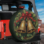 Christmas wreath with twin golden jingle bells spare tire cover shown on a black Jeep Wrangler