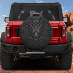 A red Jeep Wrangler with a large, intricate dragon-like design on the rear window.