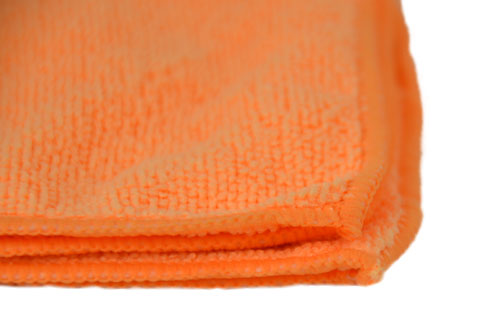 Close-up of orange microfiber cleaning cloth texture showing soft lint-free fibers for decal prep