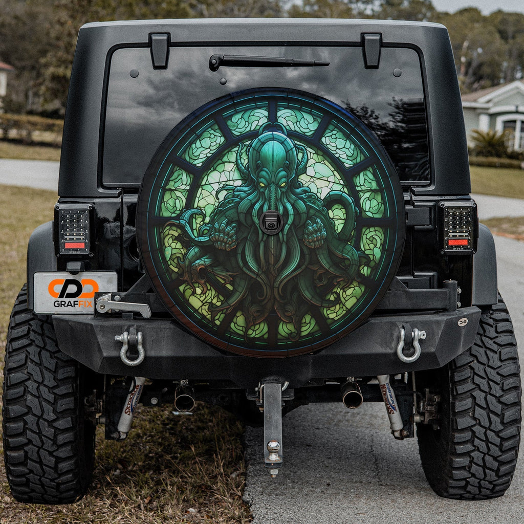 Cthulhu Rising spare tire cover on a black Jeep rear with stained glass green octopus motif and camera cutout