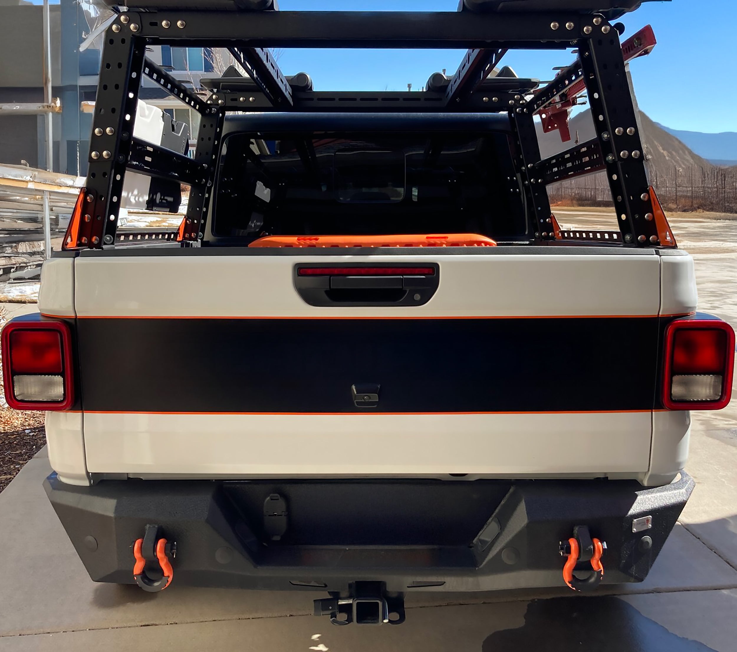 Black blackout tailgate decal with orange pinstripe border on white Gladiator JT