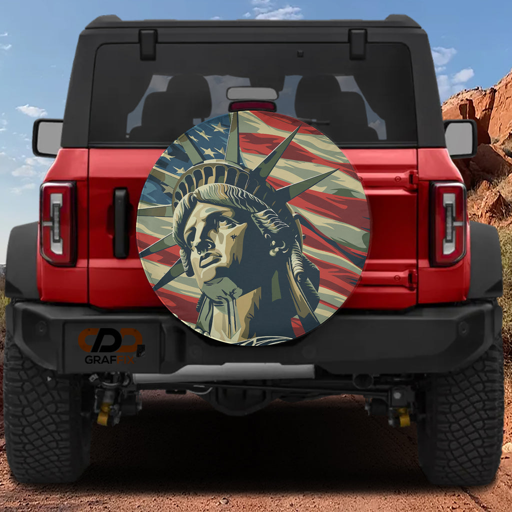 Lady Liberty's Glory spare tire cover mounted on a red Ford Bronco with desert canyon backdrop