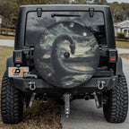 Loch Ness by Moonlight spare tire cover on black Jeep Wrangler rear with serpent rising from misty loch
