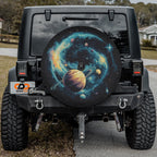 Planetary Pathways spare tire cover mounted on a Jeep Wrangler showing the cosmic artwork lit in outdoor daylight