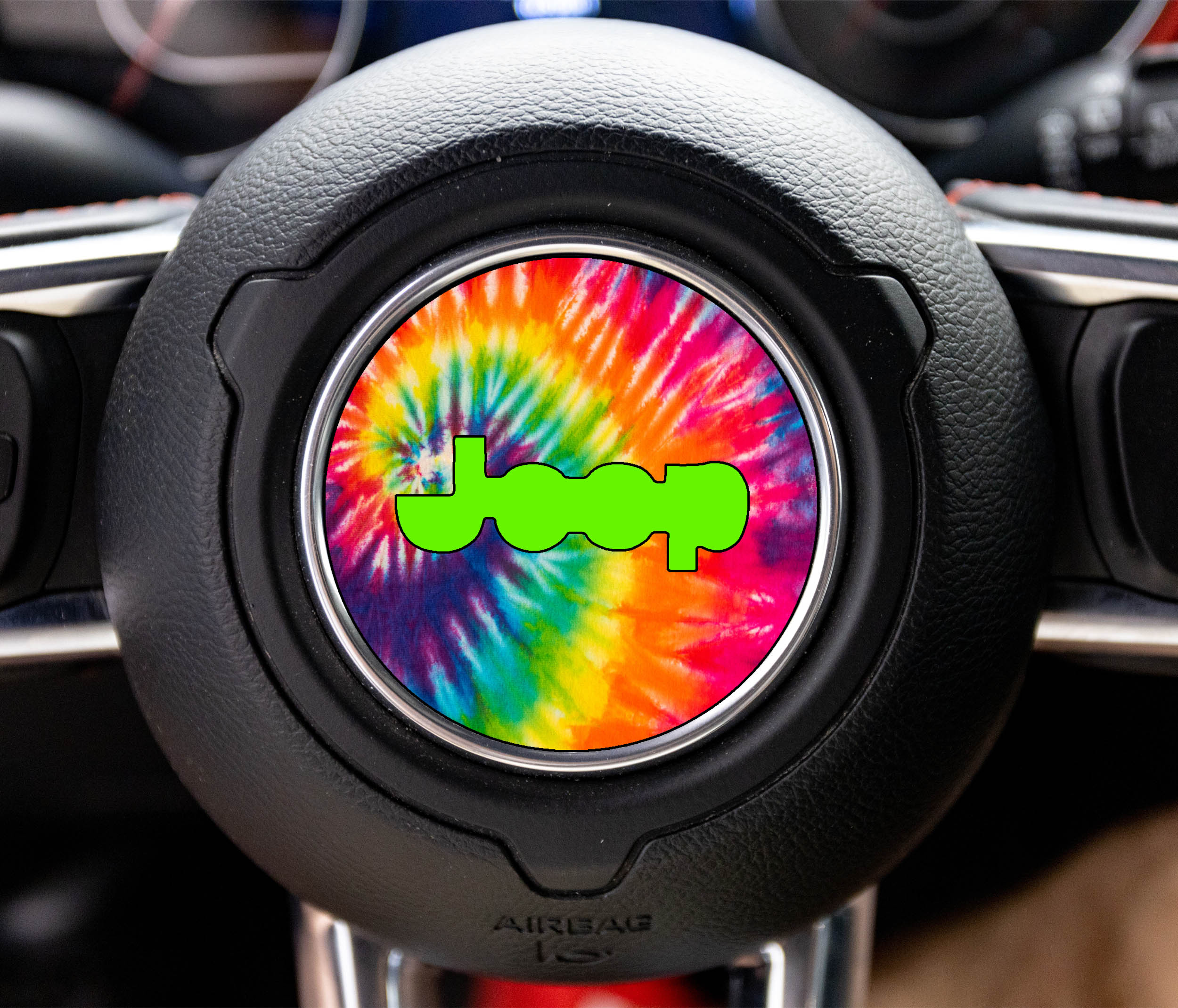 Rainbow tie dye Jeep logo steering wheel airbag center decal overlay shown on black JL wheel