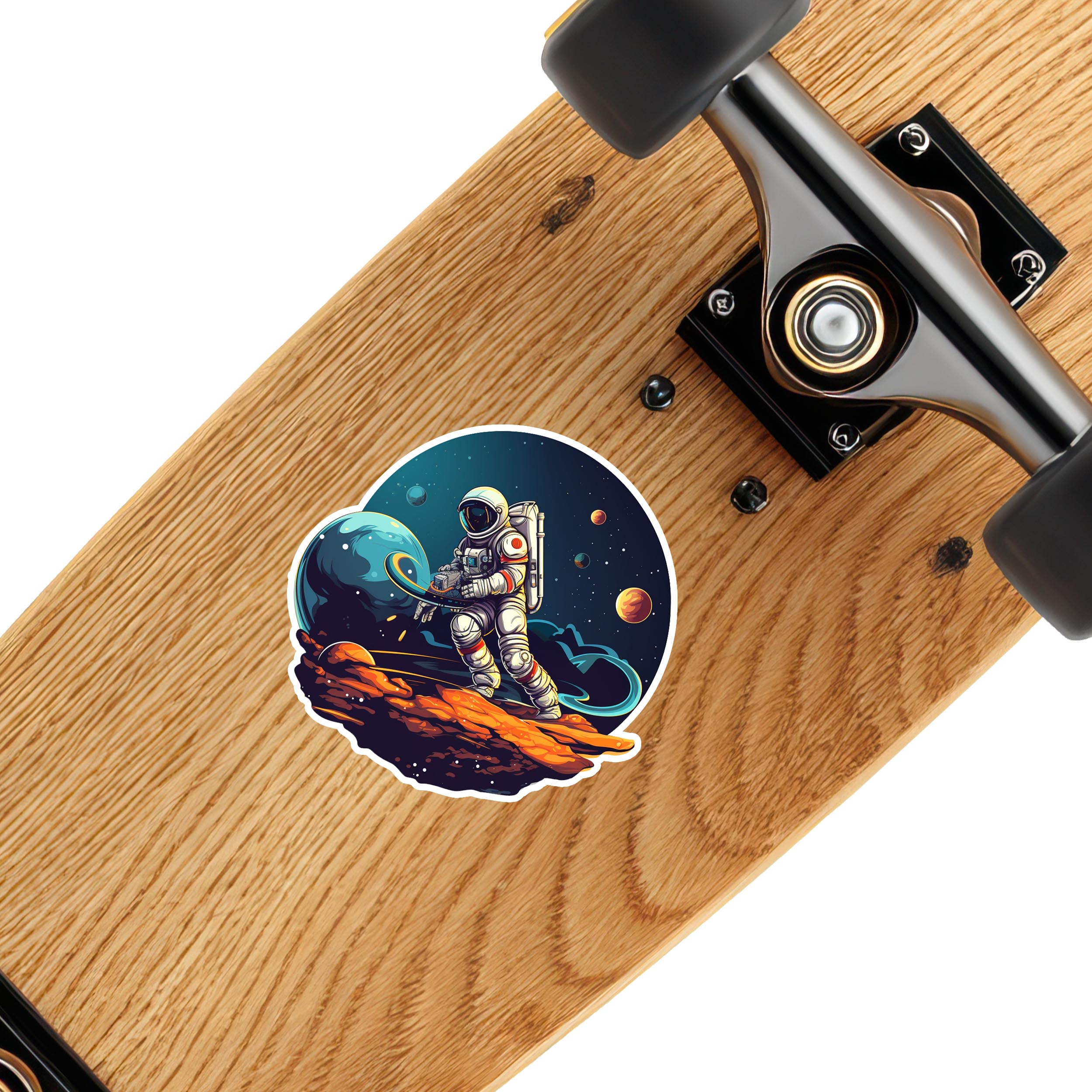 Astronaut on asteroid sticker applied to a wooden skateboard deck near black trucks to show decal scale