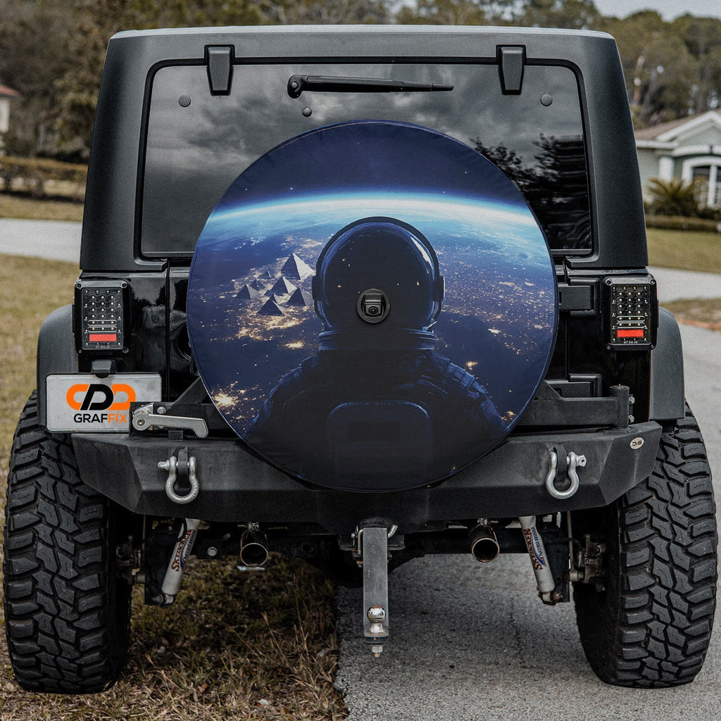 Astronaut Earth space station view spare tire cover mounted on black Jeep Wrangler with camera cutout