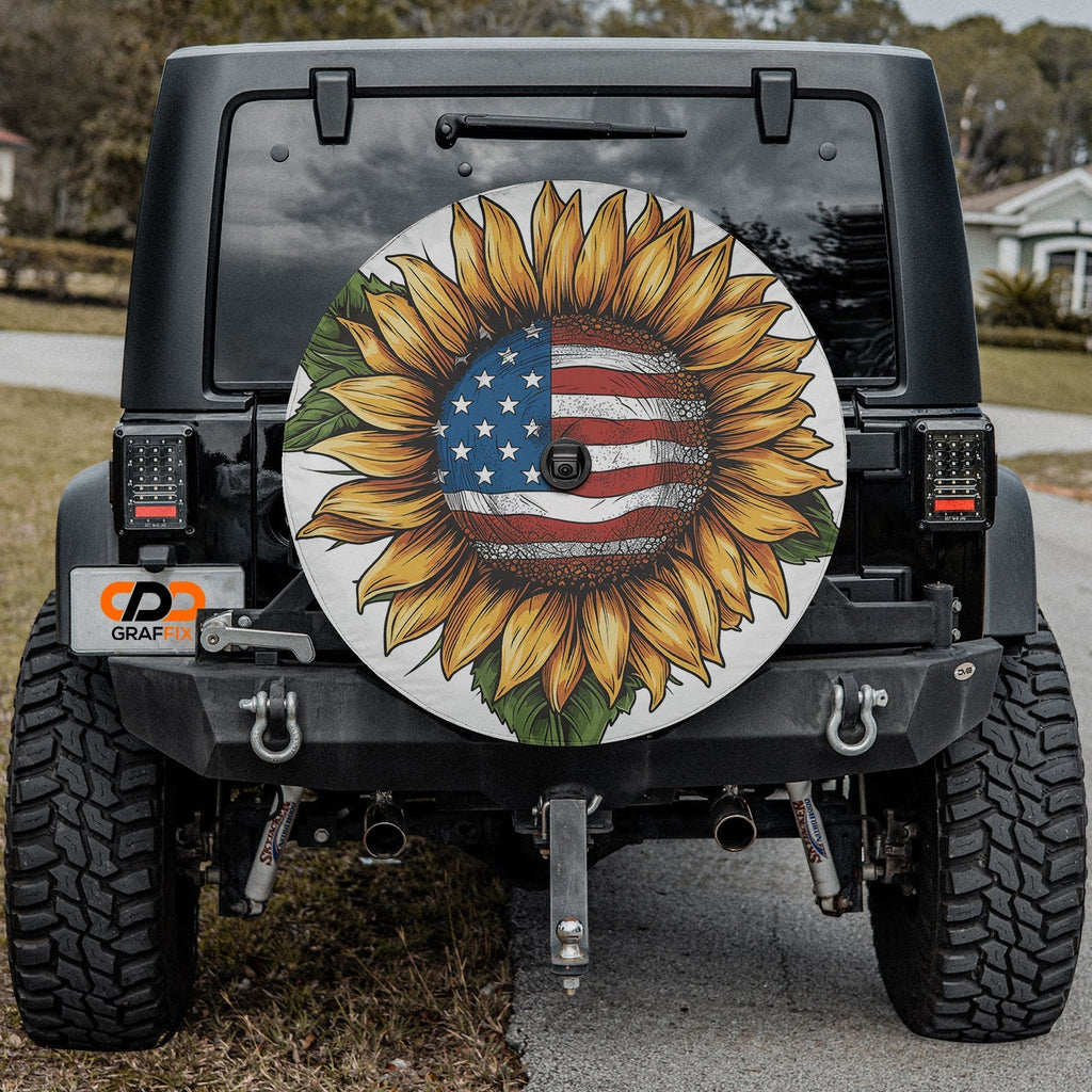 Star-Spangled Sunflower spare tire cover mounted on a Jeep Wrangler showcasing the patriotic sunflower in outdoor light