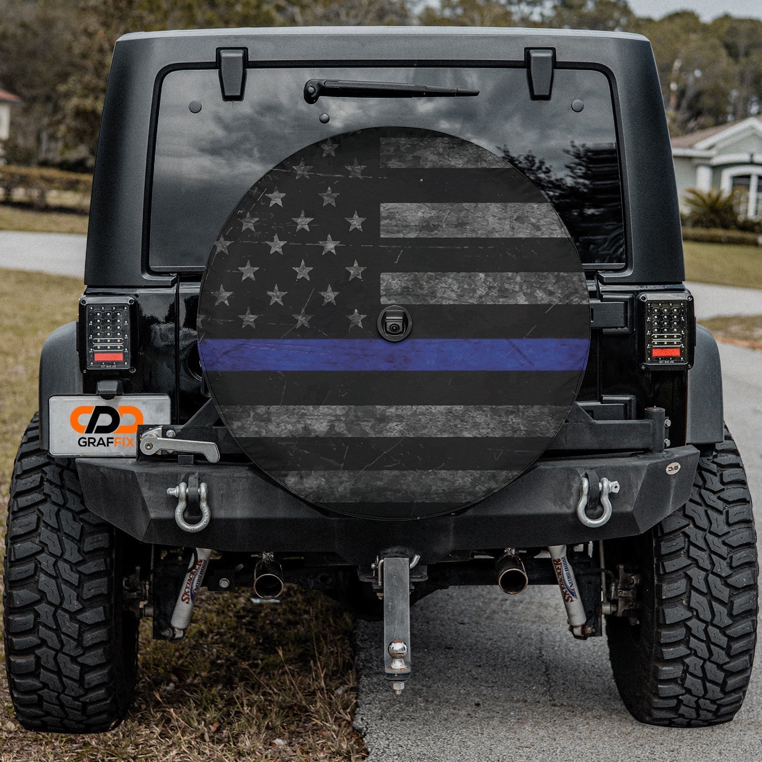 Thin blue line subdued flag tire cover on a black Jeep Wrangler with distressed stars stripes thin blue stripe