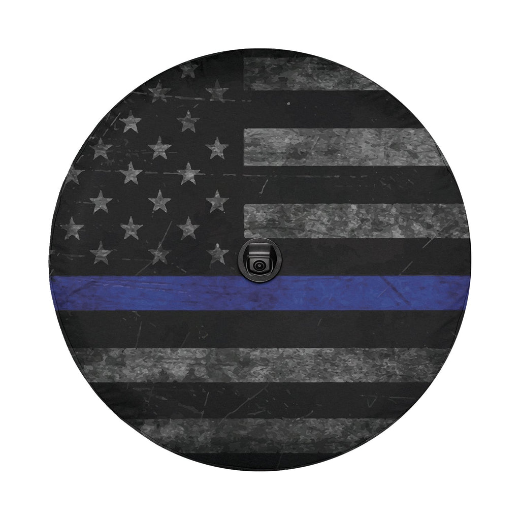 Flat round thin blue line subdued flag tire cover closeup with weathered grayscale stars and blue stripe