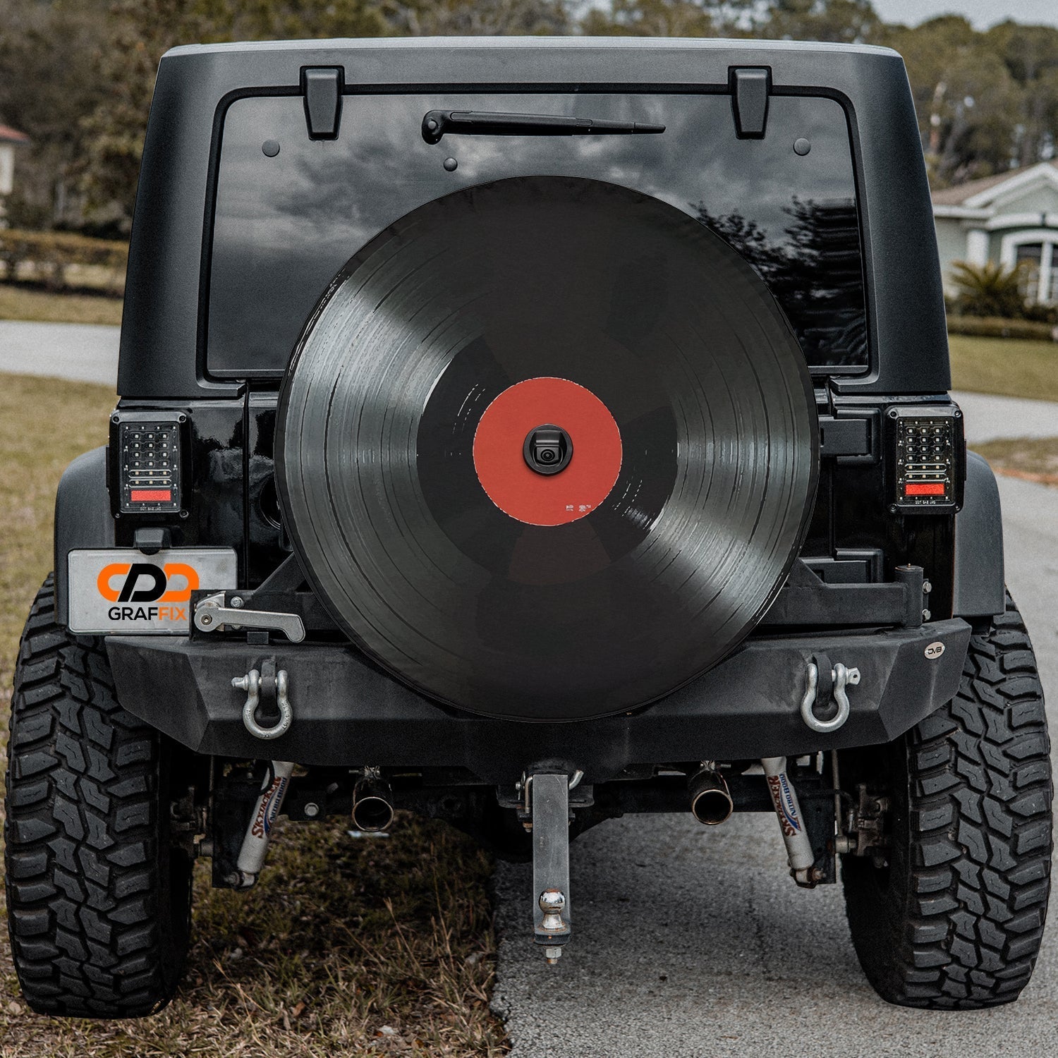 Vinyl Record spare tire cover mounted on red Jeep Wrangler rear gate showing detailed LP record art