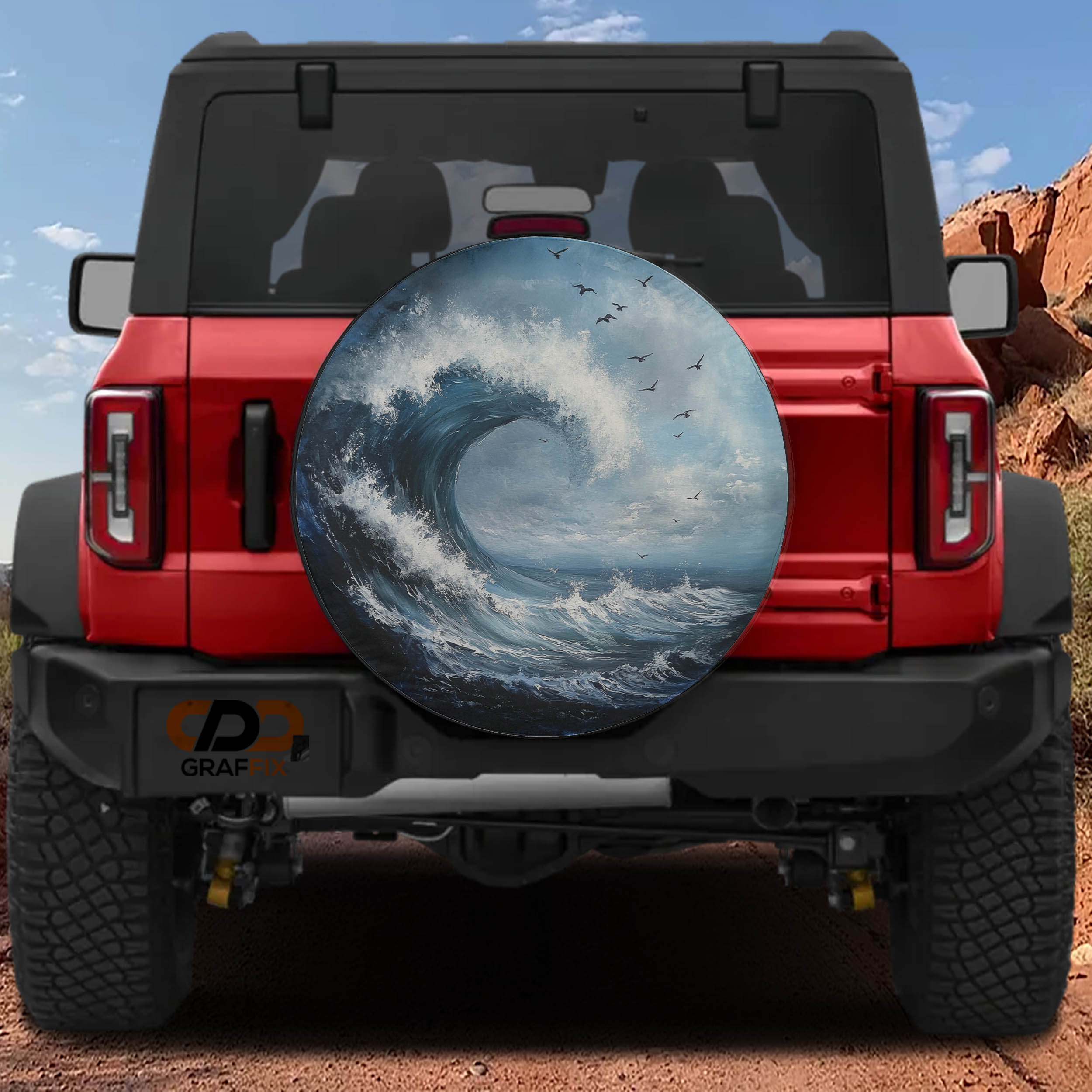 Tidal Wave spare tire cover mounted on a red Bronco rear with painted breaking ocean wave, seabirds and sky