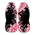 two identical flower-patterned objects, one on each side, with pink flowers and petals against a black background.