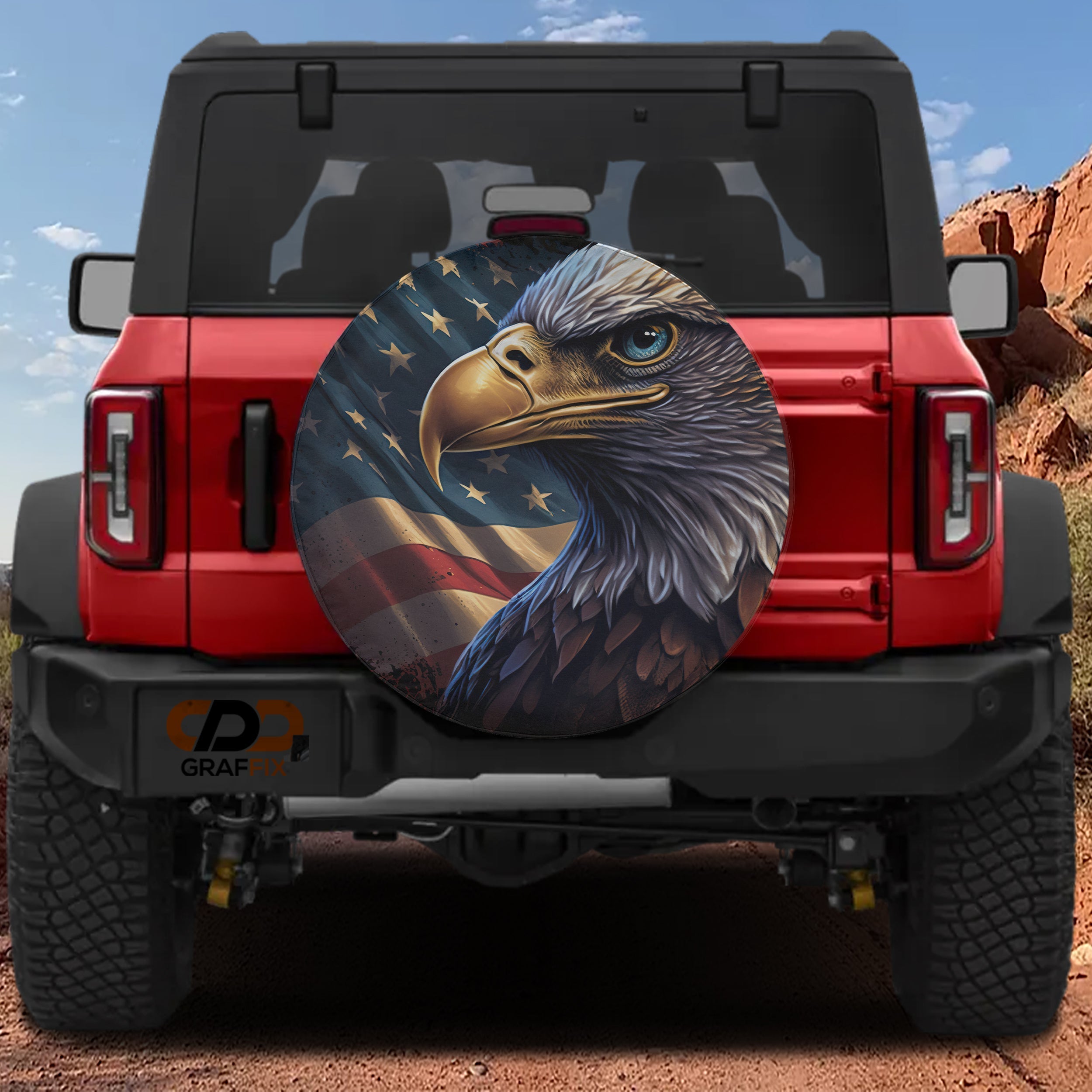 American Pride on Wheels eagle spare tire cover on a red Jeep Wrangler with patriotic flag art